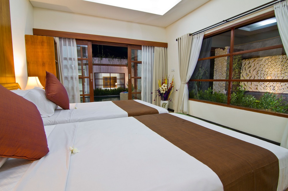 twin bedroom at villa maha with minimalist design - facing to the pool and garden